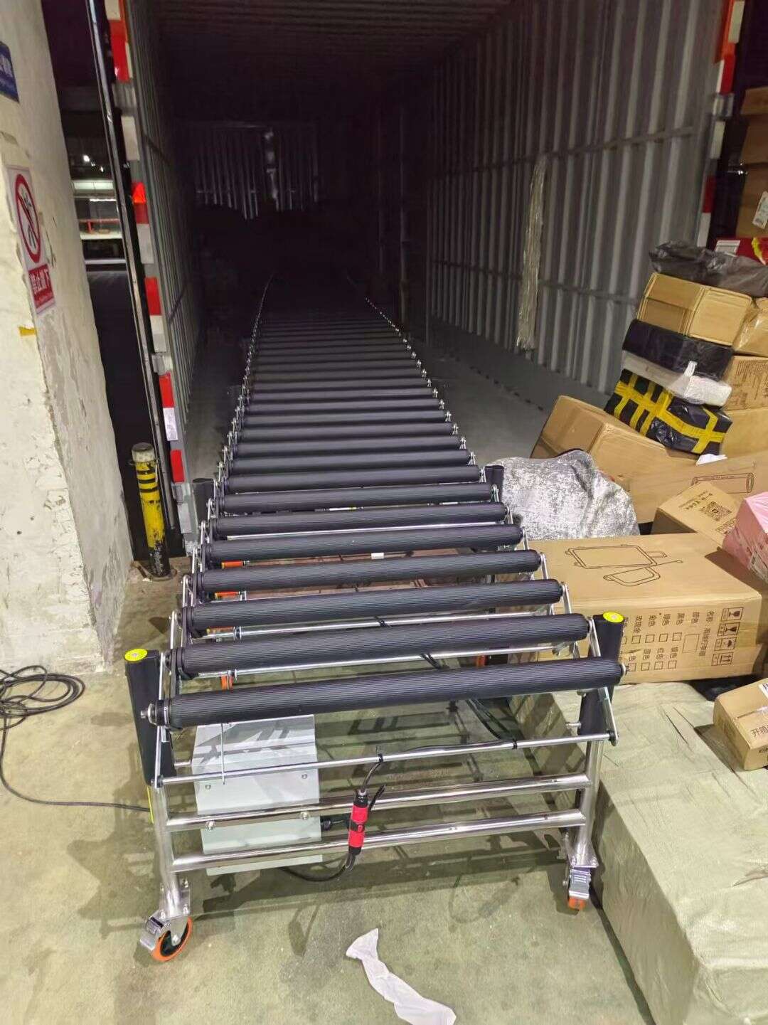 Powered Rubber-Covered Roller Conveyor inside the truck